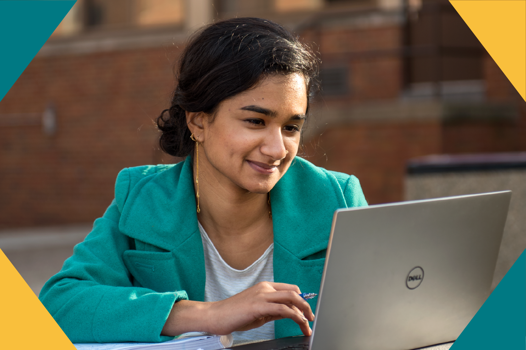 student smiling at laptop